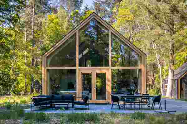 This prefab modular home includes an open floor plan + arched ceiling with curved pinewood walls!