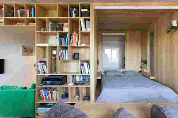 A Multifunctional wooden ‘bedroom box’ creates a whole new room and storage area for this tiny apartment!