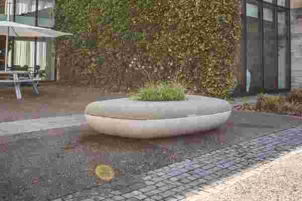 This concrete bench collects rainwater for plants that are a part of the seating!